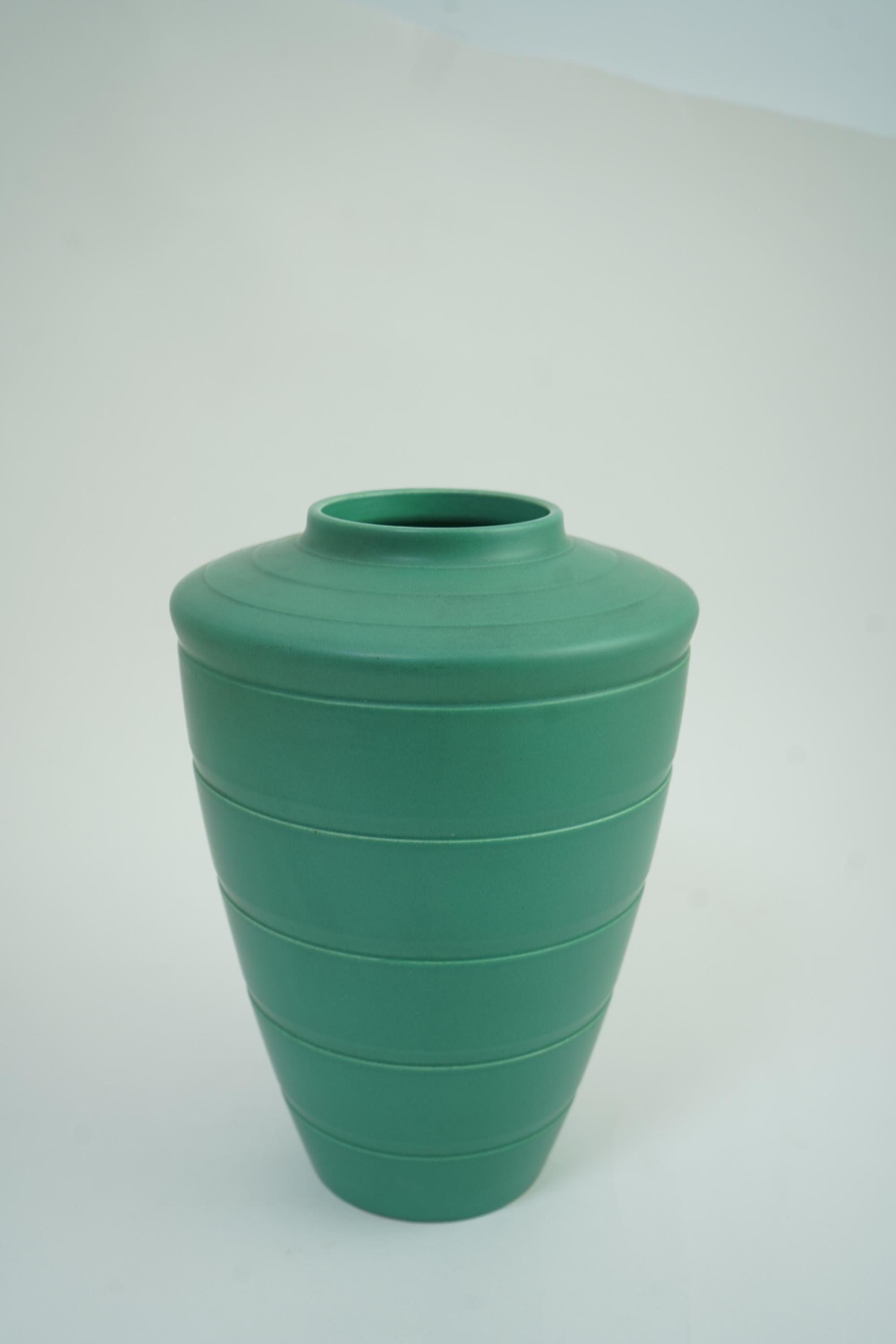 Keith Murray MC RDI FRIBA (New Zealand/British, 1892-1981) for Wedgwood: A matt green glazed tapering vase